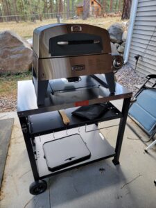 Picture of Cuisinart 3 in 1 grill, griddle and pizza oven on top of a metal Feast cart.